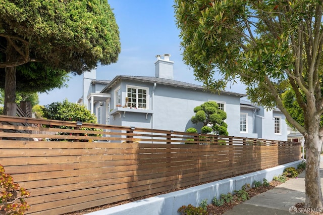 20 Rossmoor Dr, San Francisco, CA 94132 - view of front facade featuring stucco siding and a chimney