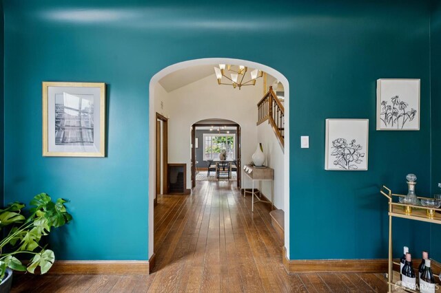 20 Rossmoor Dr, San Francisco, CA 94132 - corridor featuring arched walkways, hardwood / wood-style flooring, stairway, baseboards, and a chandelier