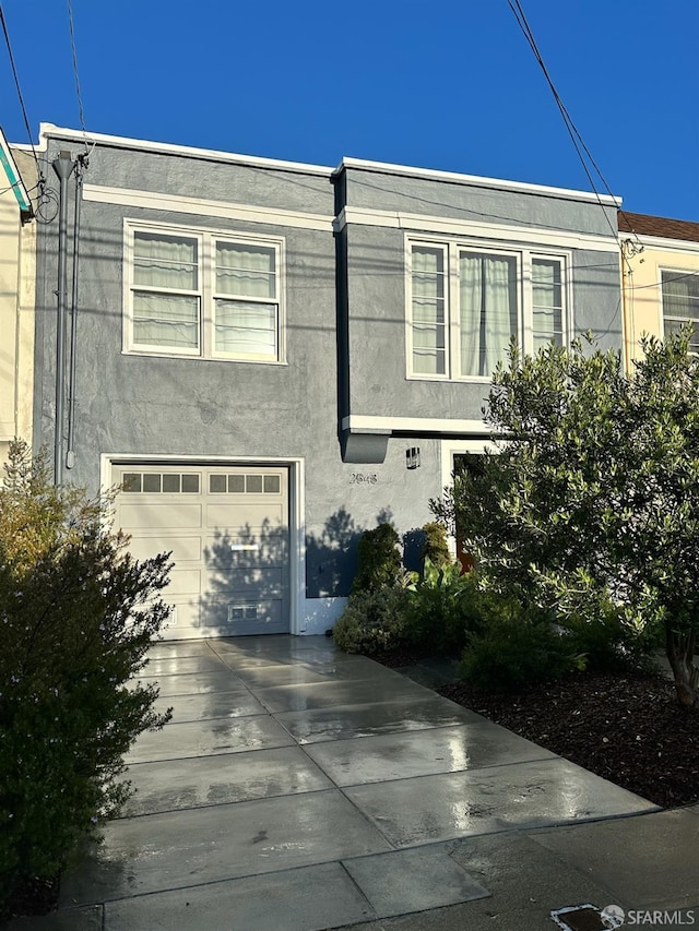 2543 44th Ave, San Francisco, CA 94116 - view of front of home featuring a garage, stucco siding, and driveway