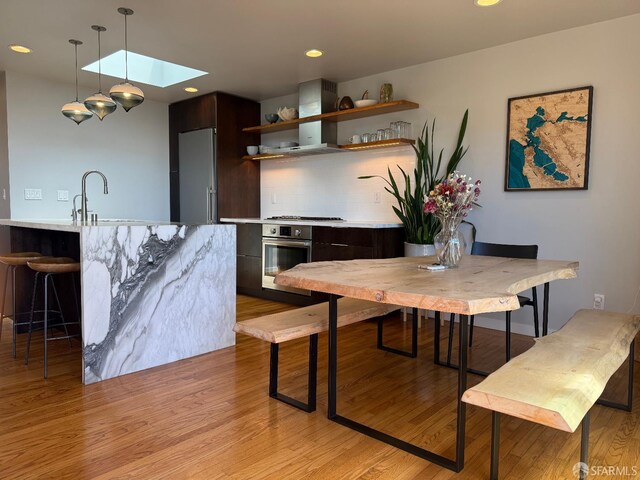 2543 44th Ave, San Francisco, CA 94116 - dining space featuring a skylight, light wood-type flooring, and recessed lighting