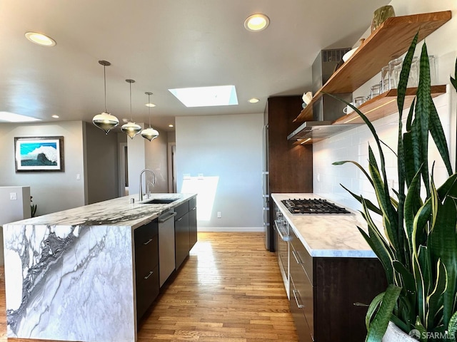 2543 44th Ave, San Francisco, CA 94116 - kitchen with a sink, open shelves, light wood-style floors, a skylight, and appliances with stainless steel finishes