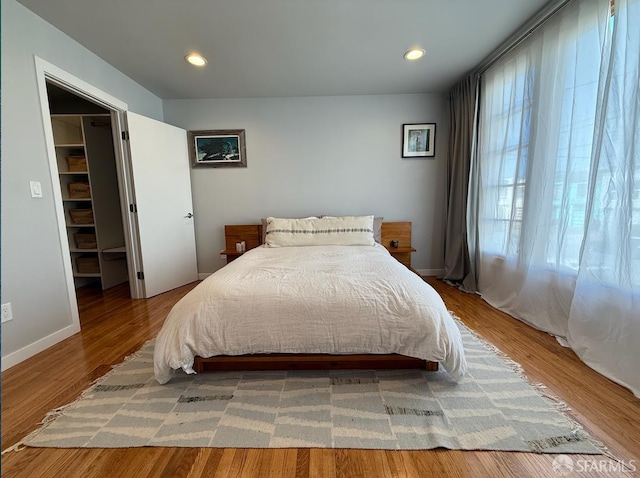 2543 44th Ave, San Francisco, CA 94116 - bedroom with a walk in closet, recessed lighting, wood finished floors, and a closet
