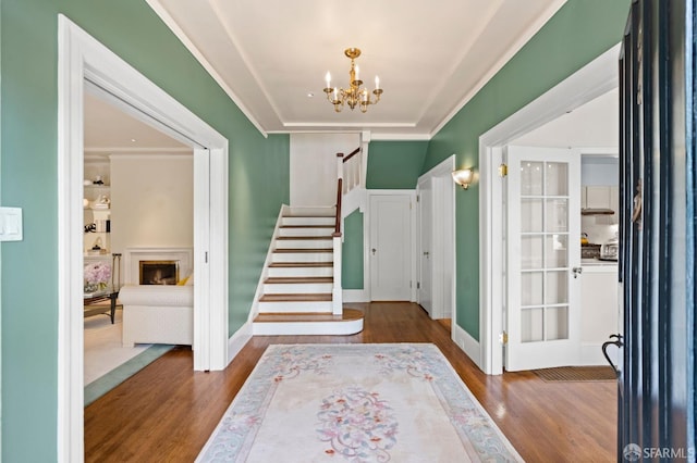 entrance foyer with hardwood / wood-style floors and a chandelier