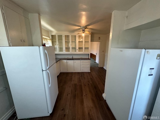 kitchen featuring white cabinetry, dark hardwood / wood-style floors, ceiling fan, and white fridge