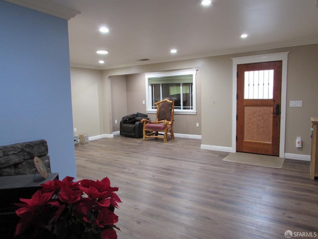 foyer entrance with wood-type flooring and ornamental molding