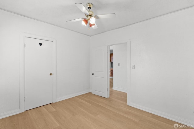 unfurnished bedroom with a ceiling fan, light wood-style floors, and baseboards