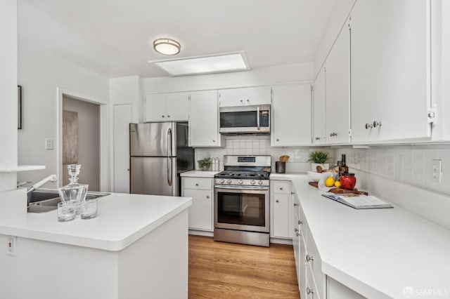 25 Roselyn Ter, San Francisco, CA 94118 - kitchen featuring appliances with stainless steel finishes, light countertops, and white cabinets