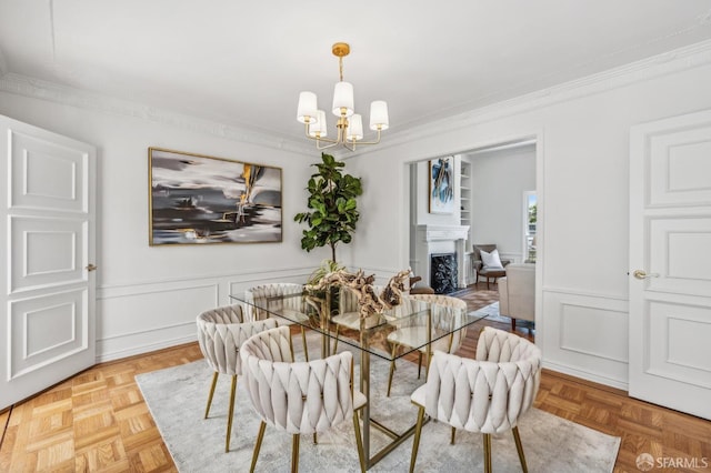 25 Roselyn Ter, San Francisco, CA 94118 - dining room with ornamental molding, a chandelier, a decorative wall, a fireplace, and wainscoting