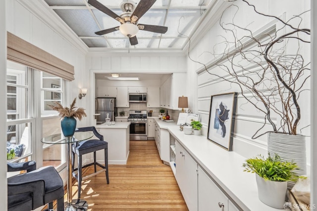 25 Roselyn Ter, San Francisco, CA 94118 - kitchen with stainless steel appliances, light countertops, light wood-style floors, ceiling fan, and white cabinetry