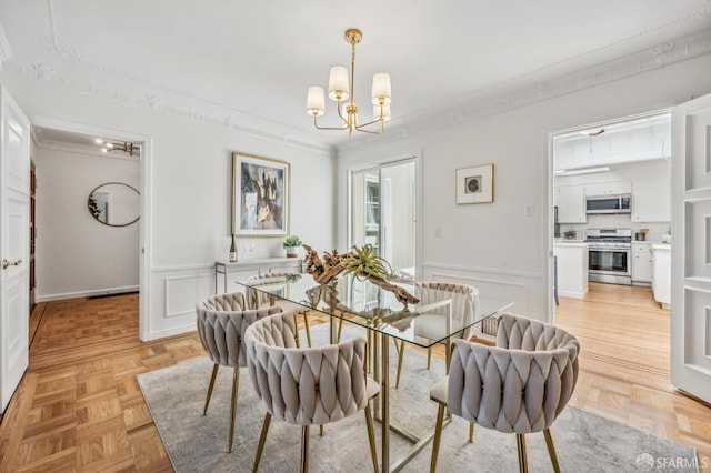 25 Roselyn Ter, San Francisco, CA 94118 - dining room featuring a chandelier, ornamental molding, a decorative wall, and a wainscoted wall