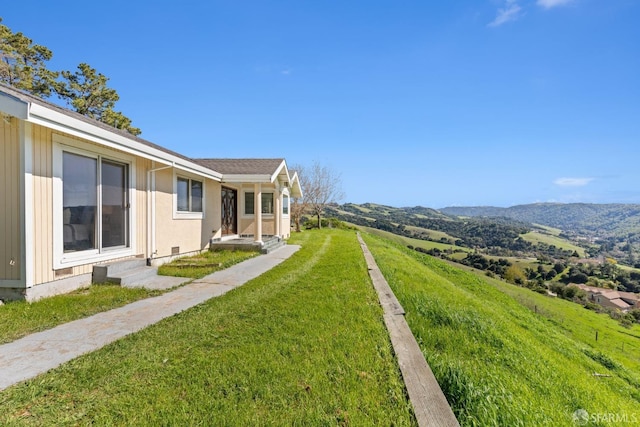 view of yard featuring a mountain view and entry steps