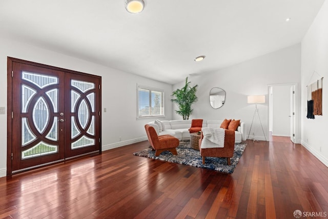 living area with vaulted ceiling, french doors, baseboards, and hardwood / wood-style floors