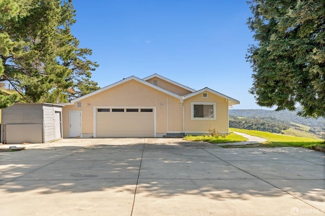 single story home with a garage and driveway