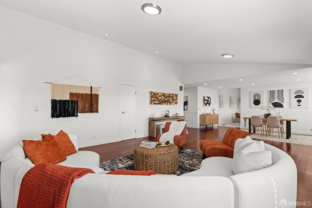 living room featuring vaulted ceiling, recessed lighting, wood finished floors, and baseboards