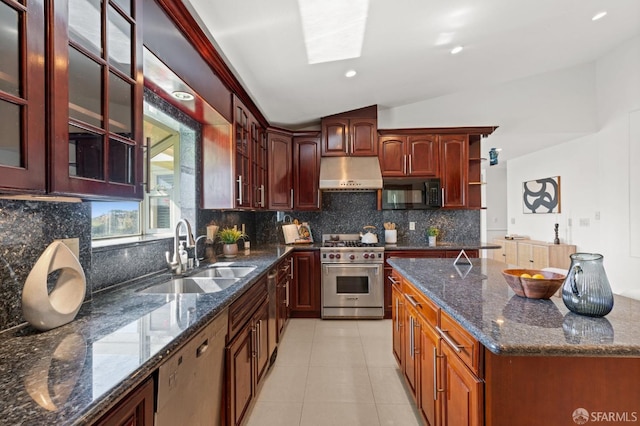 kitchen with black microwave, under cabinet range hood, luxury stove, dishwashing machine, and a sink