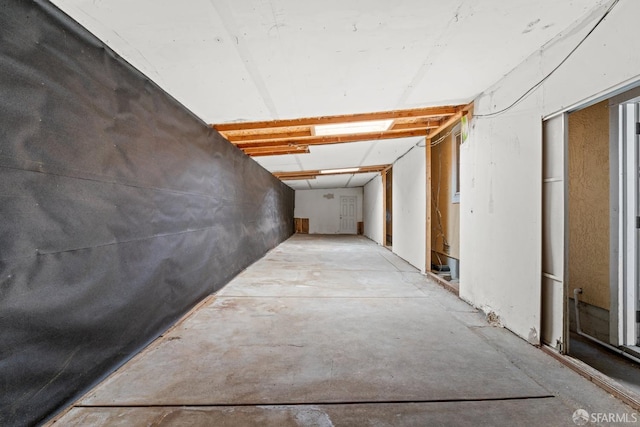 corridor featuring unfinished concrete flooring