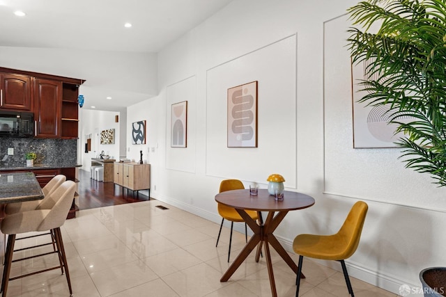 dining area with light tile patterned floors, recessed lighting, and baseboards