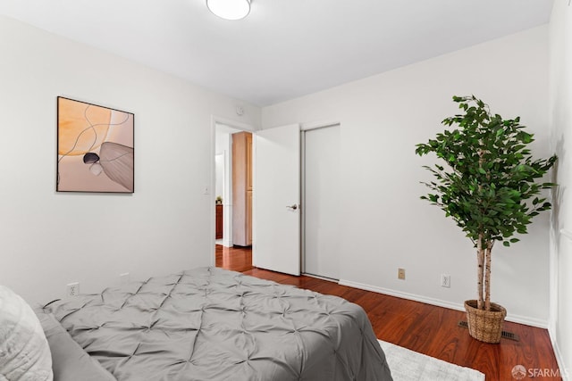 bedroom featuring baseboards and wood finished floors