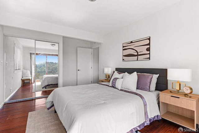 bedroom featuring access to exterior and dark wood-type flooring