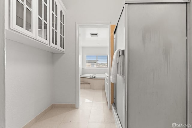 interior space featuring visible vents, baseboards, and light tile patterned flooring