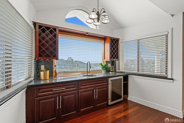 kitchen featuring a sink, beverage cooler, vaulted ceiling, a notable chandelier, and dark wood-style flooring