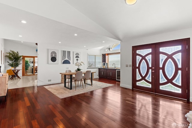 entryway featuring lofted ceiling, french doors, and dark wood-style flooring