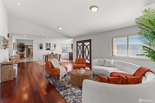 living room with recessed lighting, hardwood / wood-style floors, and vaulted ceiling