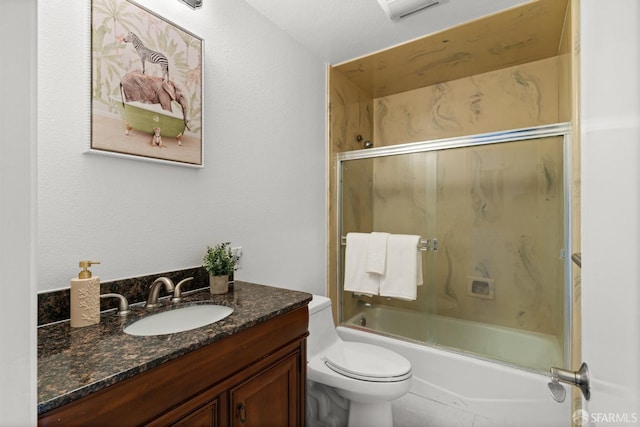 bathroom with vanity, toilet, and shower / bath combination with glass door