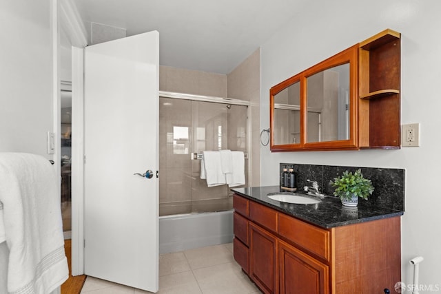 bathroom featuring tile patterned floors, vanity, and bath / shower combo with glass door