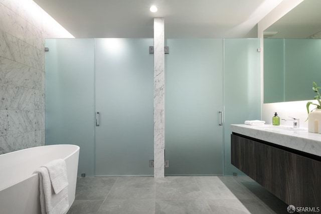 bathroom featuring tile patterned floors, vanity, and separate shower and tub