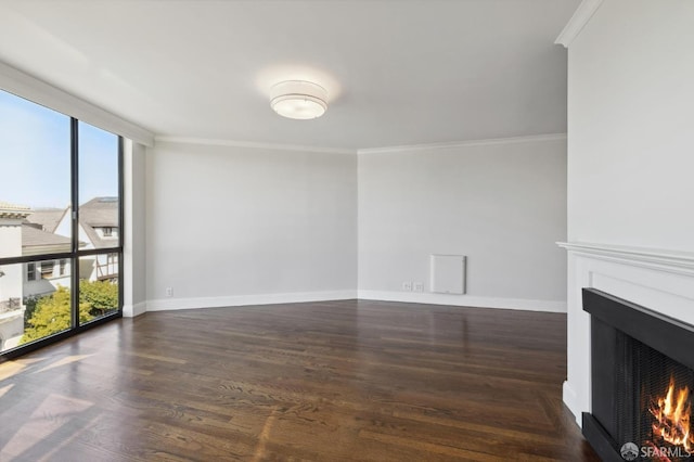 unfurnished living room with ornamental molding and dark wood-type flooring