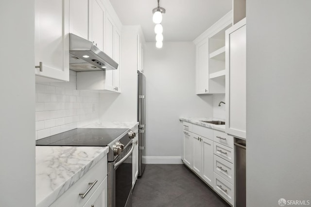 kitchen with light stone counters, white cabinets, sink, appliances with stainless steel finishes, and decorative backsplash