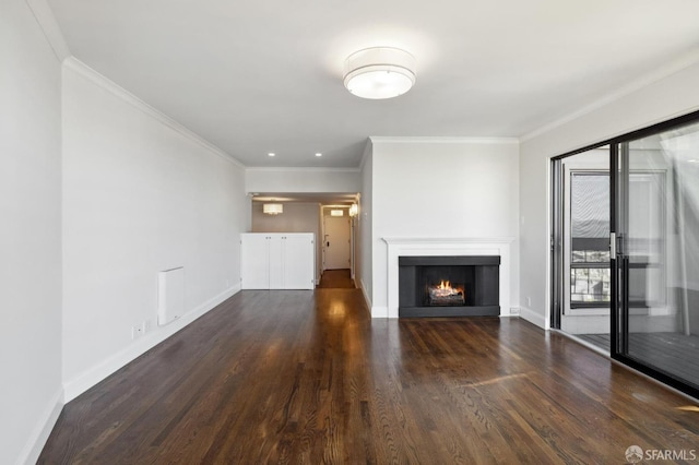 unfurnished living room with ornamental molding and dark hardwood / wood-style floors