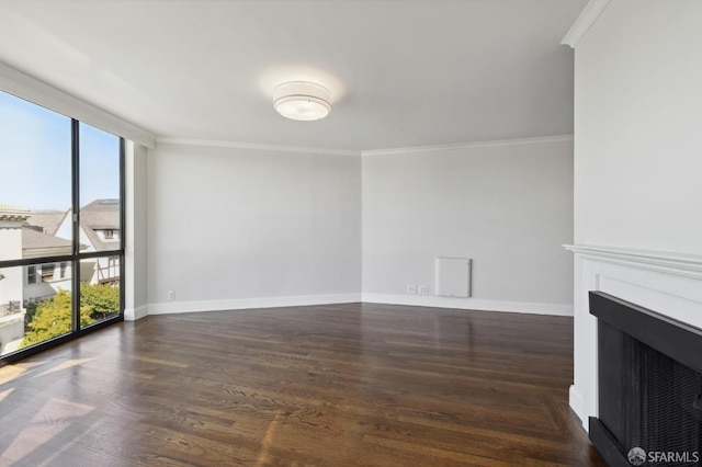 unfurnished living room with crown molding, dark hardwood / wood-style floors, and a wealth of natural light