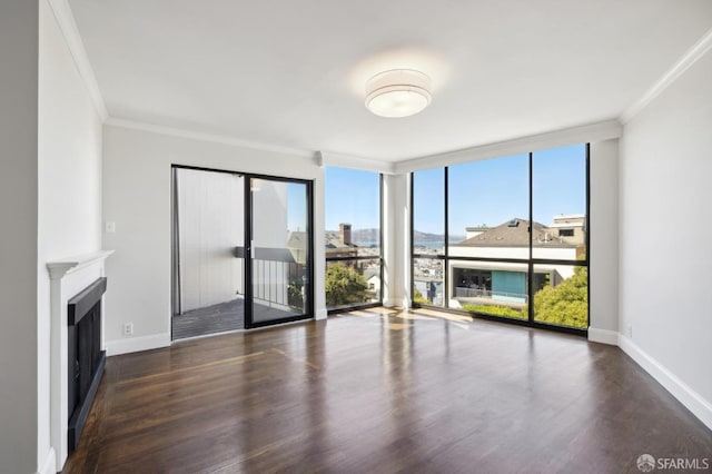 unfurnished living room with crown molding, expansive windows, and dark hardwood / wood-style flooring