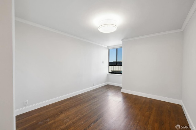 unfurnished room featuring ornamental molding and dark wood-type flooring