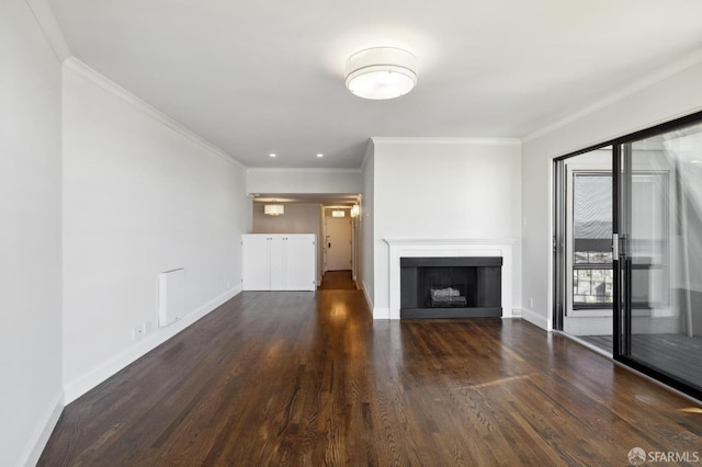 unfurnished living room with ornamental molding and dark hardwood / wood-style floors