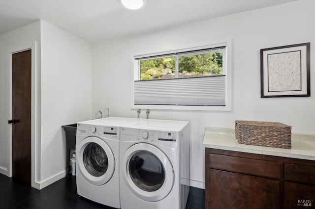 laundry room featuring washer and dryer, laundry area, dark wood-style flooring, and baseboards