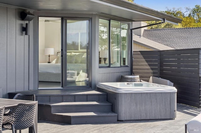 wooden deck featuring a hot tub