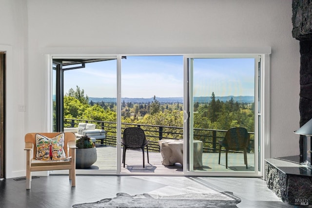 doorway to outside with a wealth of natural light, visible vents, and a wooded view