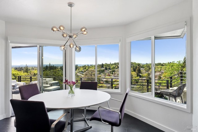 dining area with dark wood-type flooring, a chandelier, and baseboards