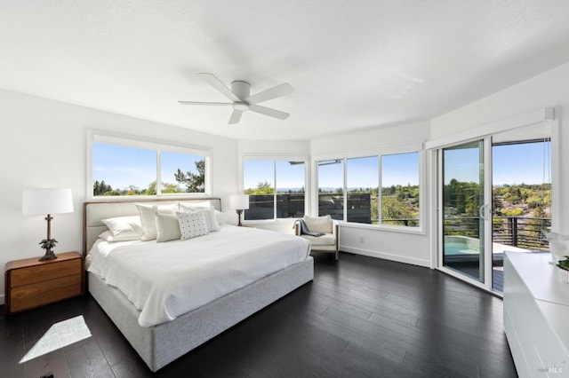 bedroom with access to exterior, dark wood-style flooring, ceiling fan, and multiple windows