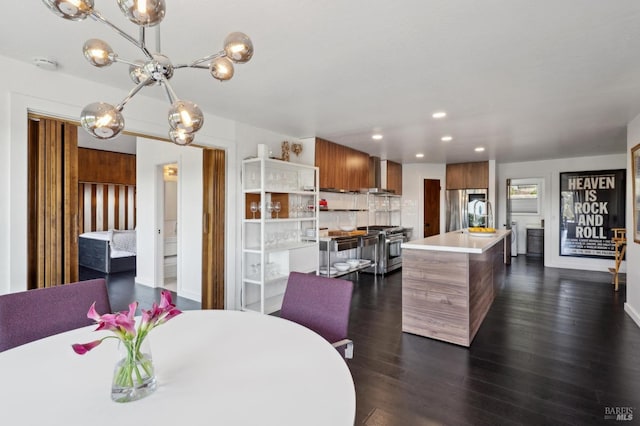 dining area featuring dark wood-type flooring, recessed lighting, and a chandelier
