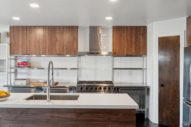 kitchen with brown cabinetry, wall chimney range hood, modern cabinets, and stove
