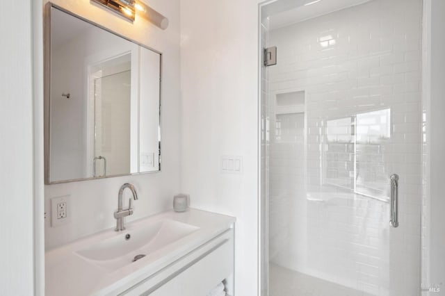 bathroom featuring a stall shower and vanity