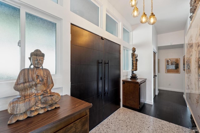 foyer with baseboards and dark wood-style floors