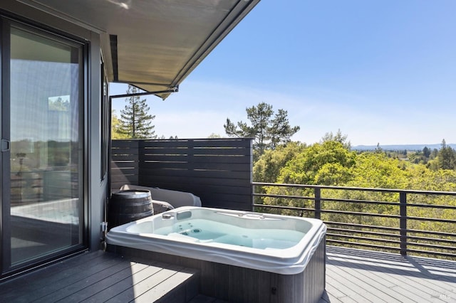 wooden terrace with an outdoor hot tub