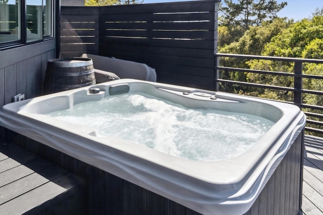 wooden terrace with an outdoor hot tub