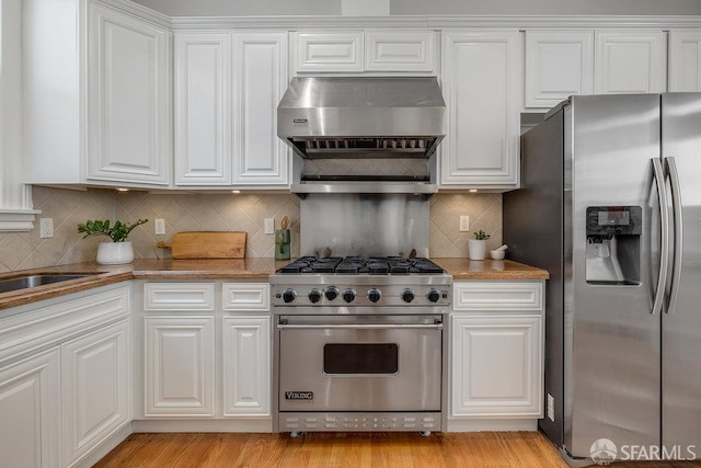813 Union St, San Francisco, CA 94133 - kitchen featuring appliances with stainless steel finishes, extractor fan, and white cabinetry