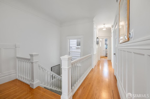813 Union St, San Francisco, CA 94133 - hall with an upstairs landing, a decorative wall, light wood finished floors, and ornamental molding